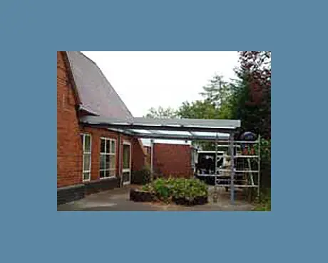 Canopy being fitted to the side of school building