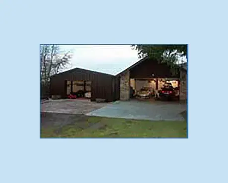 Steel portal frame building constructed to the left of existing garage facilities